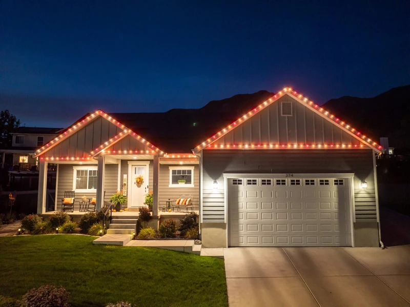 Aerial view of professional Christmas light installation outlining a full home