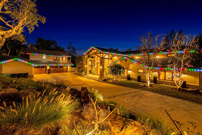 Estate Christmas light installation with red green and blue roofline LEDs