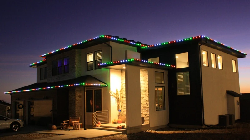 Classic red white and green Christmas lighting on a flat-roof home